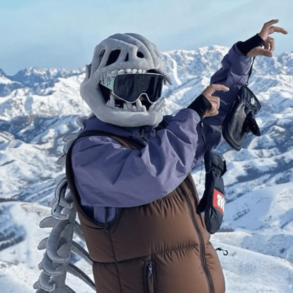 Person wearing DinoRoar costume on snowy ski mountain showing it goes anywhere